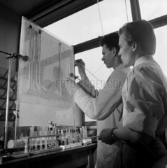 Two engineers in the research labs spraying Morganite transistors  1963.
