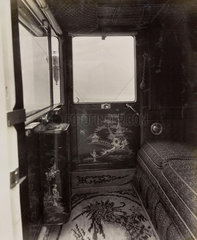 Car interior showing elaborate design and luxurious upholstery influenced by Chinese design
