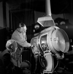 Technicians discuss a studio arc spotlight  Ship Carbon Company  1962.