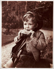 Little boy eating bread  c 1905.