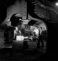 Foundry workers feed axle in to large forge hammer  Swindon  1952.