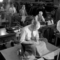 Group of middle aged tailors at work on benches  Montague Burton  Leeds.