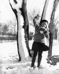 A small girl preparing to throw a snowball  27 January 1935.