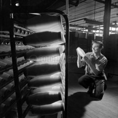 A man inspects a moulded fibreglass bottle in textile department  1967.