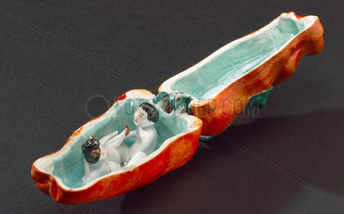 Porcelain red pepper containing a man and woman having sex.