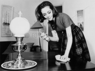 Woman polishing the living room table  28 May 1963.
