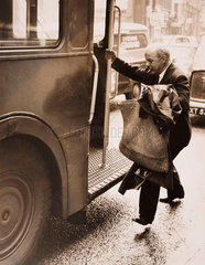 John Betjeman jumping onto a bus  London  29 March 1962.