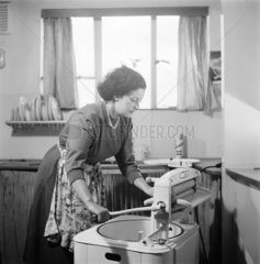 Woman using a mangle  1955