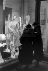 Two women window-shopping for lingerie  c 1930s.