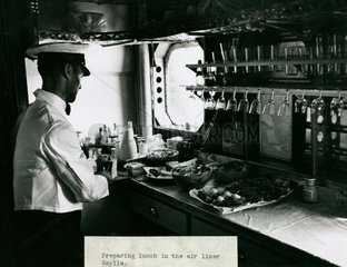 The steward prepares lunch in the galley of an Imperial Airways Scylla  1934.
