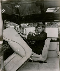 [Short chassis saloon car?] Interior shot with driver showing tipping front seat