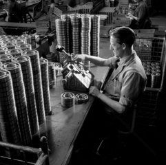 A worker rivets ball bearing cases  Skefco plant  Luton  1957.