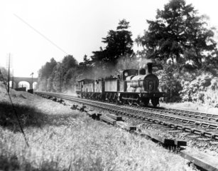 L.M.S. No. 3196 locomotive heads a short fr