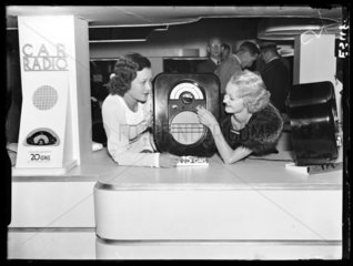 Women with an Ekco portable radio  Radiolympia  London  1935.