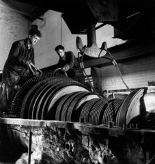 Two men dismantle the rotors of a large turbine  Sheffield  1961.