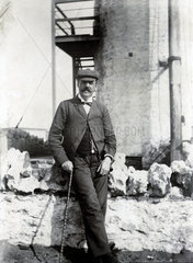 Man leaning against a wall  late 19th-early 20th century.