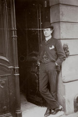 C S Rolls standing in a doorway wearing a bowler hat and suit  c 1902.