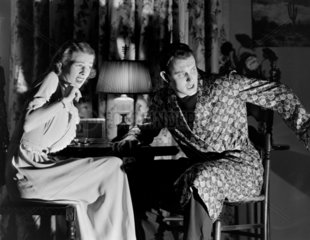 Alarmed couple in a darkened room  1956.