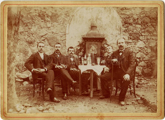 Group of men drinking absinthe  c 1900.