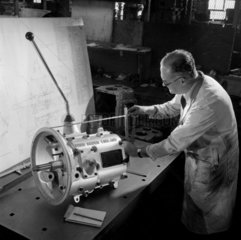 An engineer inspects gear box  David Brown  Huddersfield  1959.
