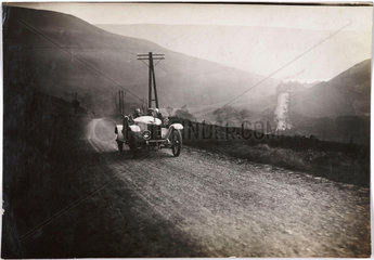 Motor car on a country road  c 1912.