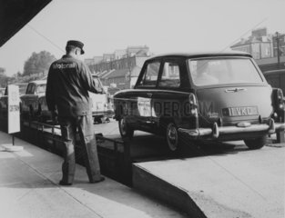 Car being driven onto a Motorail transporter  c 1966.