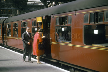 Two passengers getting onto a train  Liverpool Street station  London  1963.