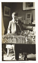 Boy playing with toy soldiers  c 1912.