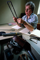 Inspecting a specimen of titanium  Science Museum  London  c 1988.