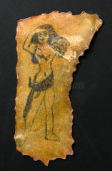 Tattoo of a naked woman on human skin  French  1880 to 1920?