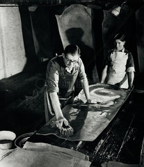 Master and young man hand oiling shoe leather at Beverley tannery  1954.