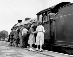 Schoolchildren chat to the driver and fireman of steam locomotive  June 1955.