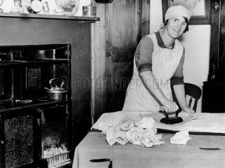 Woman ironing in the kitchen  1 October 1936.