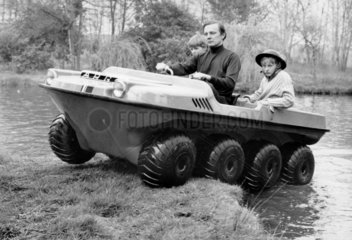 Man with two boys in amphibious vehicle  22 April 1971.