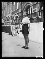 Woman holding a lightweight bicycle  1934.