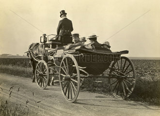 People riding in an open carriage  England  c 1901-1910.