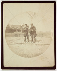Two men on a boardwalk  c 1890.