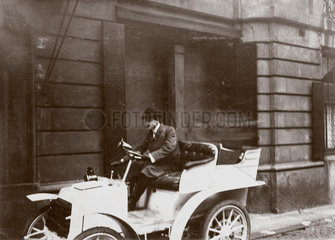 C S Rolls behind the wheel of his 7 hp Panhard motor car  c 1903.