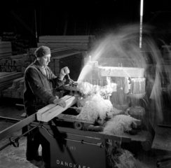 Stream of shavings as Carpenter mortices blocks of wood  1959.