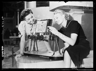 Women demonstrating an Ekco radio  Radiolympia  London  1938.