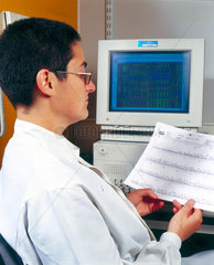 Molecular geneticist analysing the output of a DNA sequencer  May 2000.