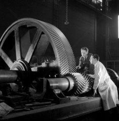 Two engineers inspect large interlocking gear wheels  David Brown  1959.