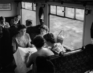 Senior girls in the compartment of a train en route for Norwich  June 1955.