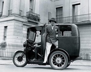 Man posing on a three-wheeler taxi  27 June 1932.