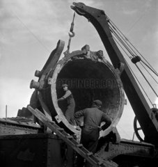 Men repairing ladle used in steel production  Workington   1952.