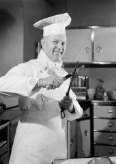 Chef sharpening a knife  1949.