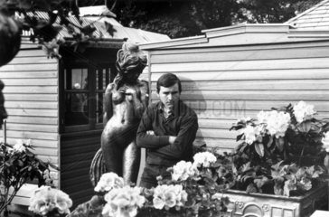 Man with statue at a flower show  c 1960s.
