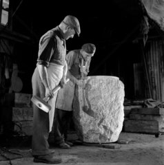 Two men work on a plinth for a church font   Granite works  Penryn  1963.