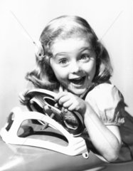 Young girl in a toy car  USA  1940s. Young
