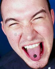 Man showing tongue pierced with stud  July 2000.
